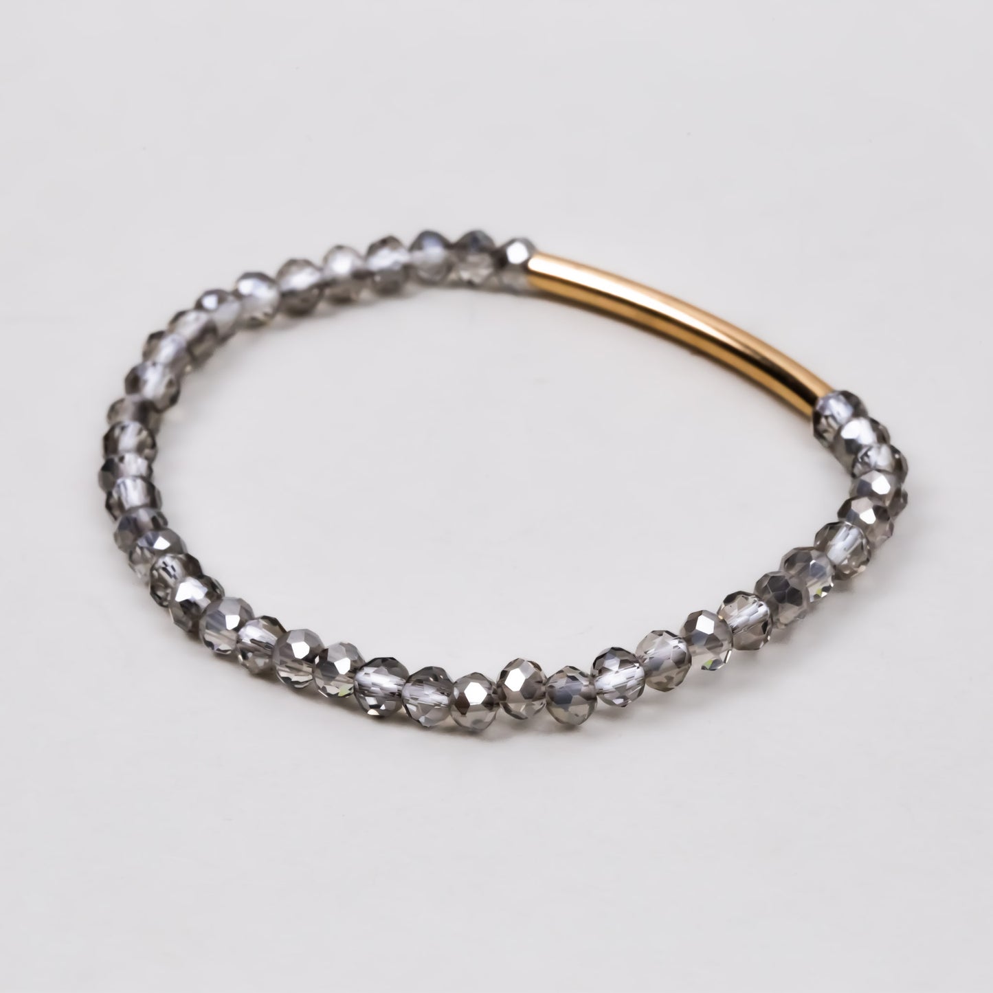 Brățară elastică cu accent auriu și pietre mici translucide - Gri